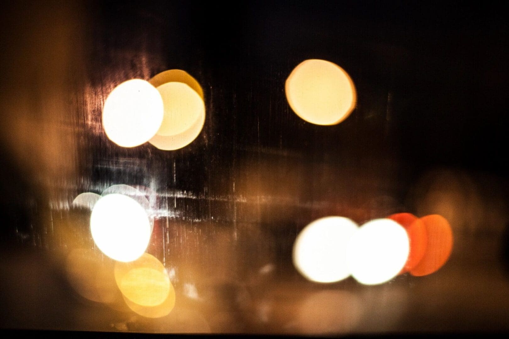Out-of-focus street lights at night, creating a bokeh effect.