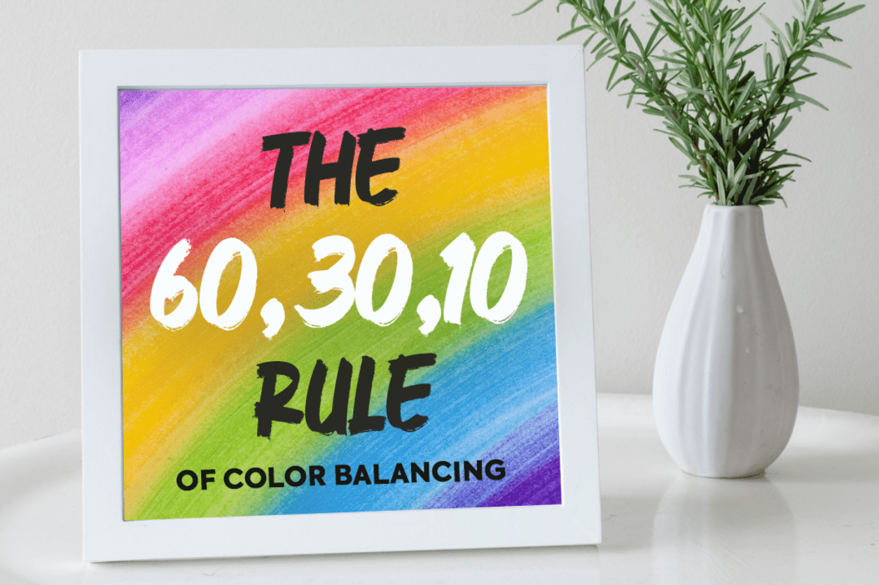 A framed graphic with a rainbow gradient background displaying the text "the color balancing rule" on a white shelf next to a vase with a green plant.