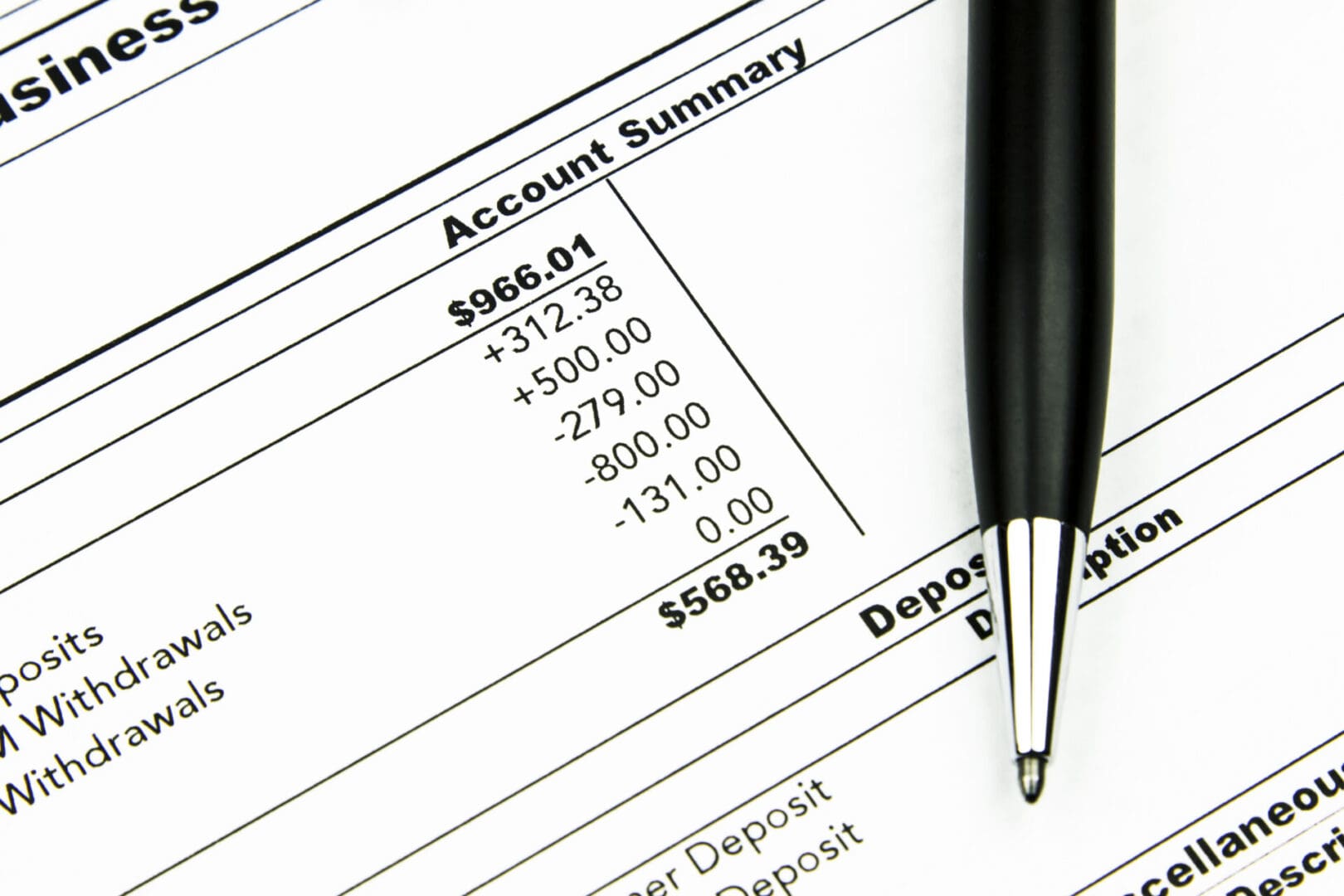 Bank Statement A pen resting on a financial statement showing Residential Programs US account summary figures.