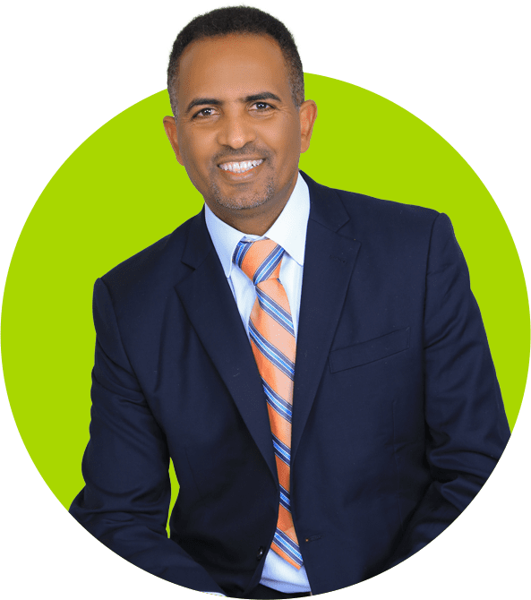 Preferred professional man in suit and striped tie smiling against a green background.