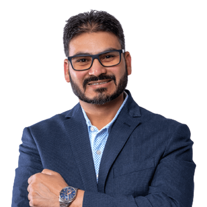 Preferred professional man in a blue suit with crossed arms smiling at the camera.