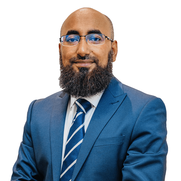 A preferred professional man with a beard wearing a blue suit and tie against a white background.