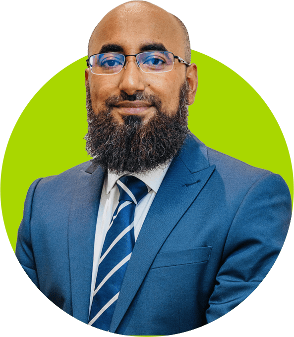 A preferred professional bearded man in glasses wearing a blue suit and striped tie.