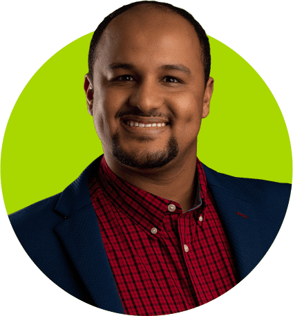 Smiling man in red shirt and blazer.