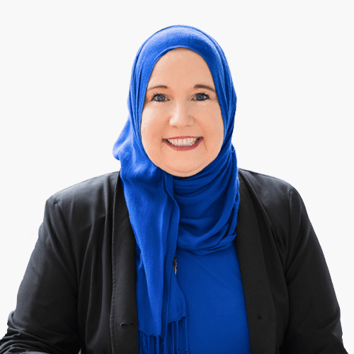 Smiling woman in blue hijab and jacket.