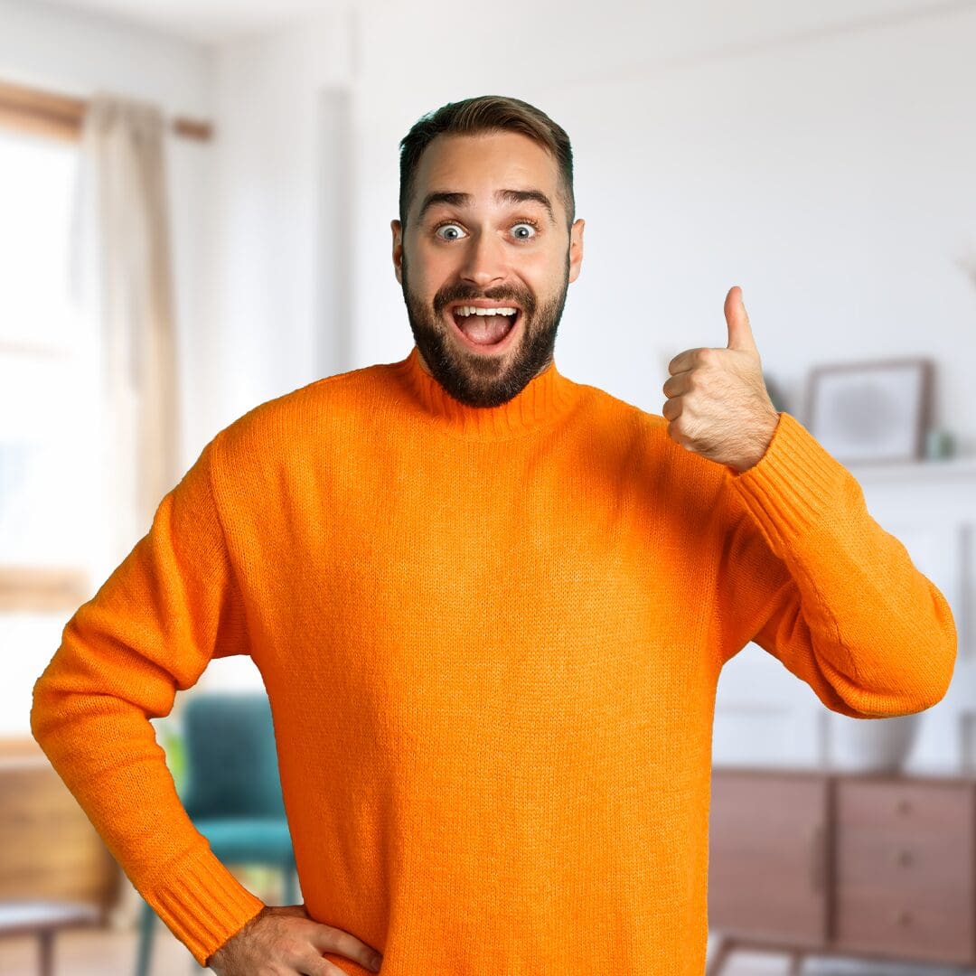 Man in orange sweater giving thumbs up.