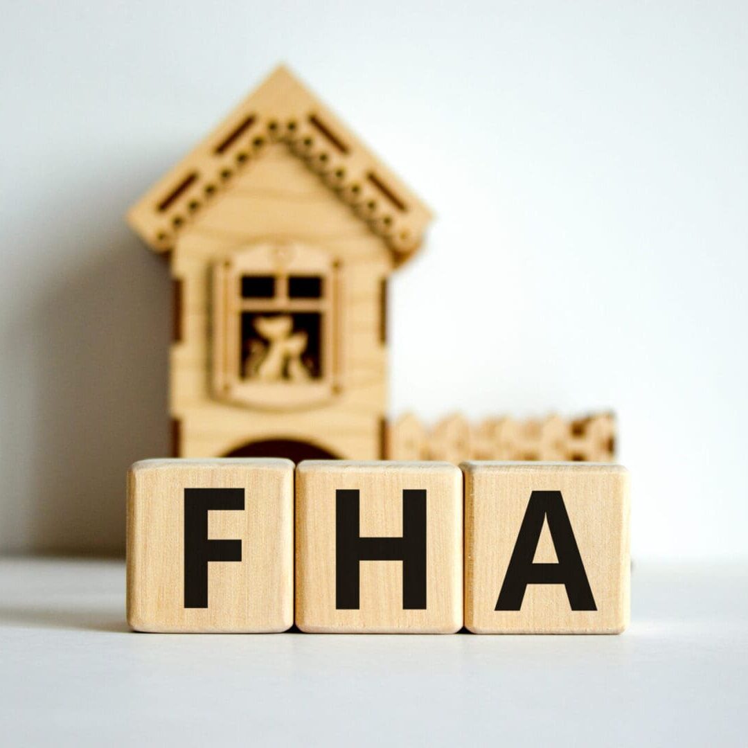 Wooden blocks with letters "fha" in front of a miniature house model, representing residential Islamic financing alternative programs in the US. Wooden blocks with letters "fha" in front of a miniature house model, representing residential Islamic financing alternative programs in the US.