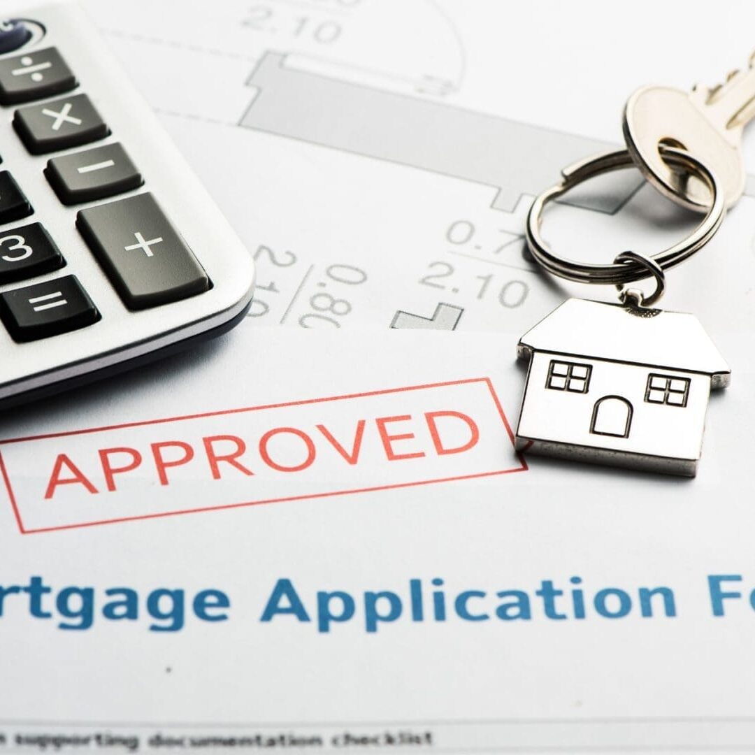 Approved mortgage application form with keys, a calculator, and a conversion chart.