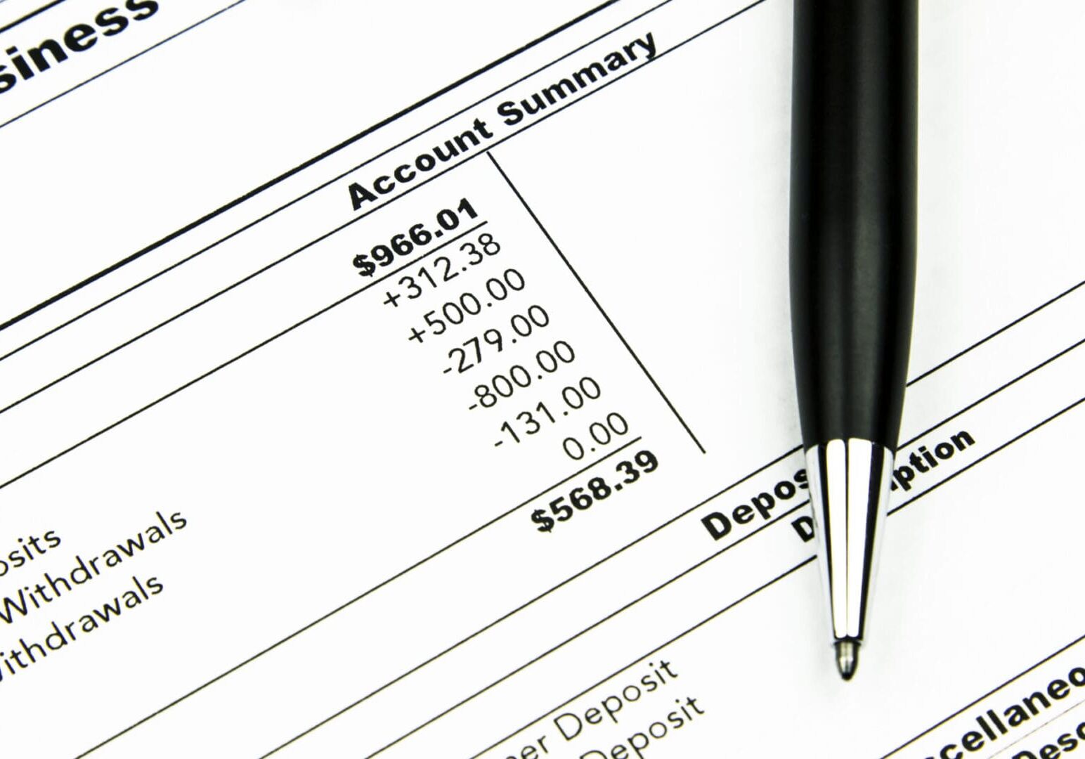 A pen resting on a financial statement showing Residential Programs US account summary figures.