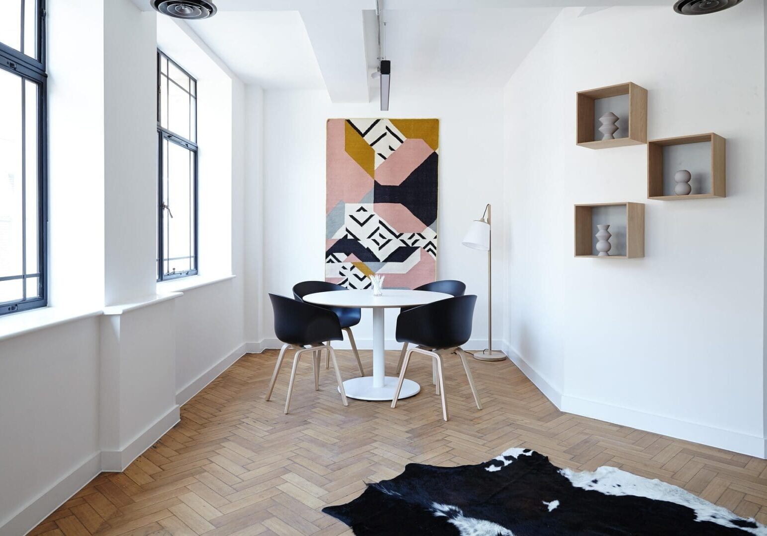 Modern dining area with abstract wall art.