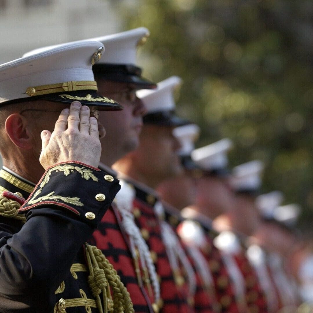 Uniformed military personnel performing a salute in a formal ceremony at a Residential Program in the US. Uniformed military personnel performing a salute in a formal ceremony at a Residential Program in the US.