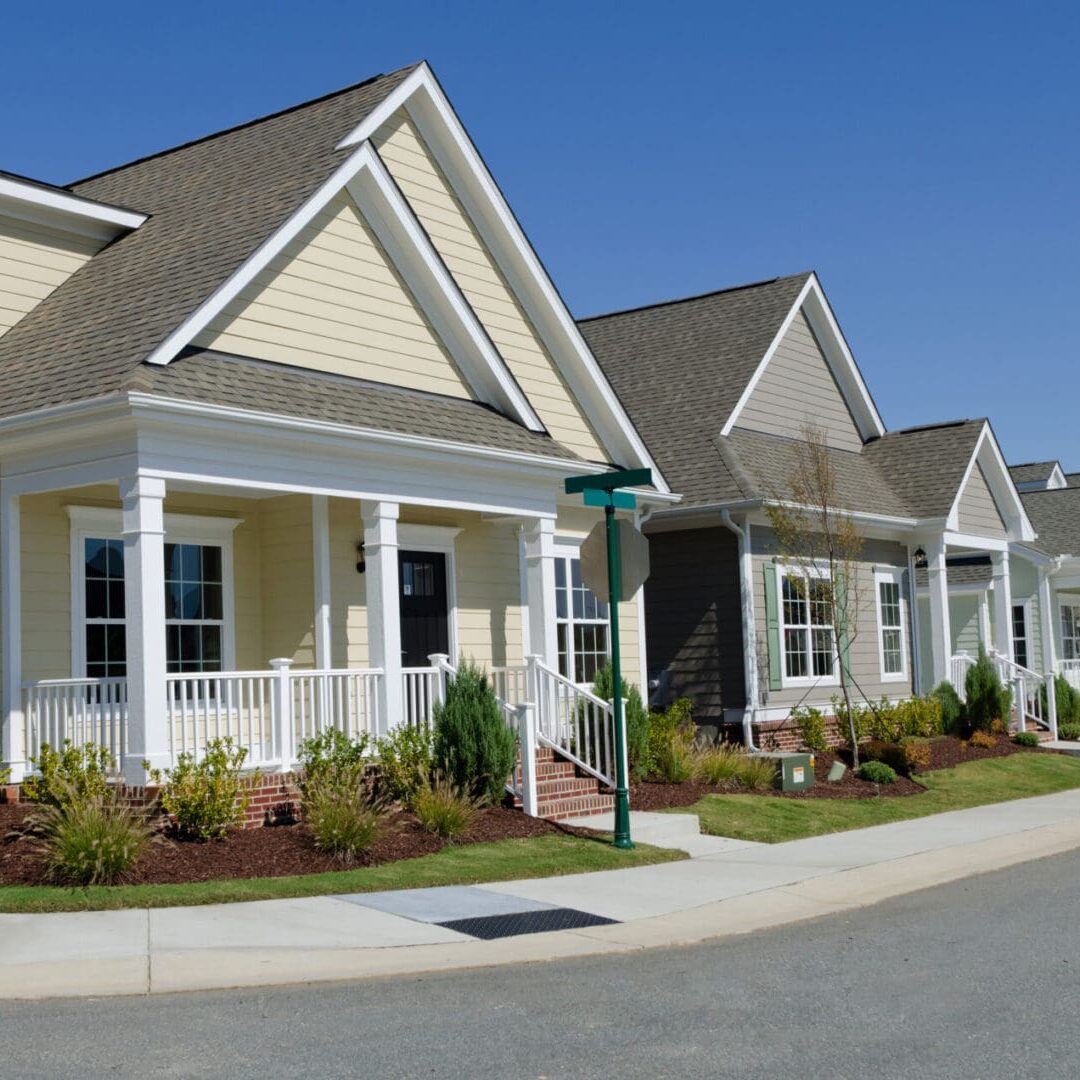 New suburban homes in a residential programs area in the US with clear skies. New suburban homes in a residential programs area in the US with clear skies.